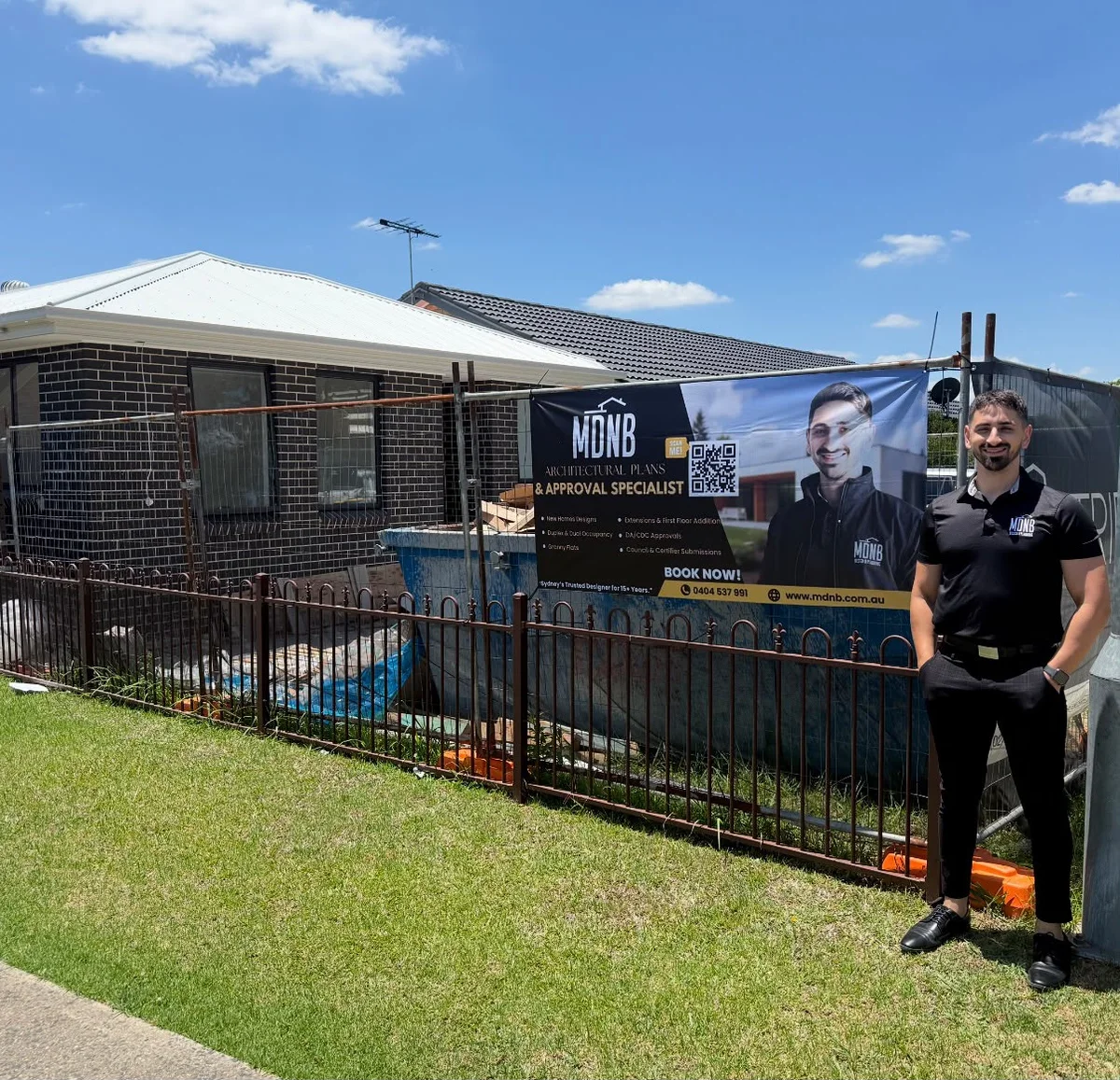 Mark Adams beside MDNB signage at a residential building site